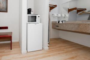 a kitchen with a microwave on top of a refrigerator at Red Roof Inn & Suites Rome in Rome