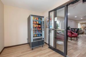 a room with a refrigerator with drinks in it at Red Roof Inn & Suites Rome in Rome