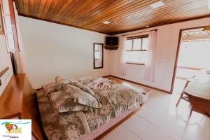 Cama ou camas em um quarto em Pousada Caúca