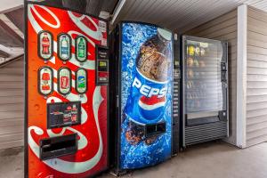 two pepsi machines are parked next to each other at HomeTowne Studios by Red Roof Atlanta - Chamblee in Atlanta