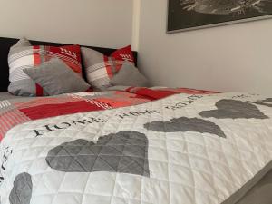 a bedroom with a bed with a quilt on it at Sauerlandblick - Appartement & FeWo Wickede in Wickede (Ruhr)