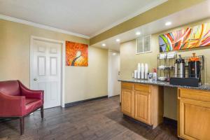 a kitchen with a counter and a red chair at Red Roof Inn Cincinnati Airport–Florence/ Erlanger in Erlanger