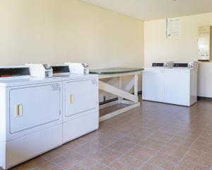 a room with two washing machines and a table at Red Roof Inn Montgomery - Midtown in Montgomery