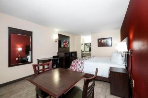a hotel room with a bed and a table at Red Roof Inn Rock Hill in Rock Hill