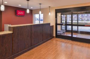 a lobby with a bar with a sign on the wall at Red Roof Inn & Suites Danville, IL in Danville