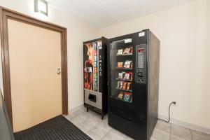 a black refrigerator is next to a door at Red Roof Inn Annapolis in Annapolis