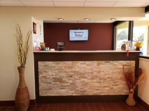 a fireplace in a waiting room with a tv above it at Red Roof Inn Portsmouth - Wheelersburg in Wheelersburg