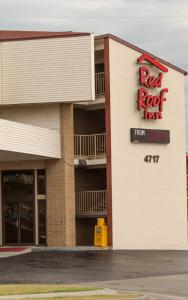 a large building with a sign on the side of it at Red Roof Inn Tulsa in Tulsa