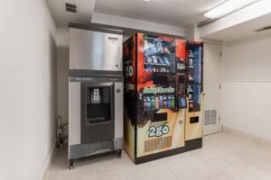 a soda machine in a room with a drink dispenser at Red Roof Inn PLUS+ Columbus - Worthington in Columbus