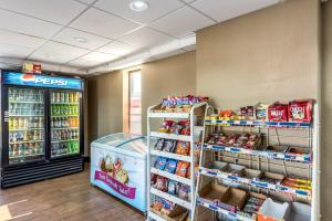 a store aisle with a refrigerator and shelves of food at Red Roof Inn & Suites Pigeon Forge Parkway in Pigeon Forge