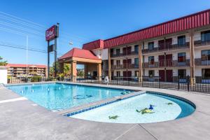 a swimming pool in front of a hotel at Red Roof Inn & Suites Pigeon Forge Parkway in Pigeon Forge