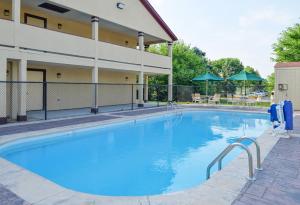 a large swimming pool in front of a building at Red Roof Inn Indianapolis - Greenwood in Greenwood