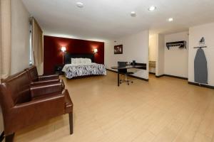 a hotel room with a bed and a desk at Red Roof Inn Jacksonville - Cruise Port in Jacksonville