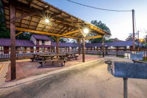 a picnic pavilion with picnic tables and lights at Red Roof Inn Starkville - University in Starkville