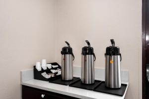 two silver and black thermos sitting on a counter at Red Roof Inn Bristol in Bristol