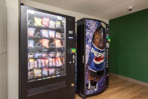 a vending machine filled with drinks and soda at HomeTowne Studios by Red Roof Raleigh – Durham in Durham