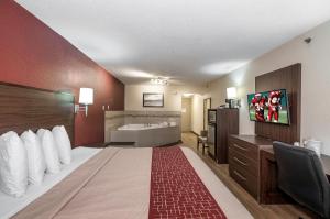 a hotel room with a bed and a bathroom at Red Roof Inn Lancaster in Lancaster