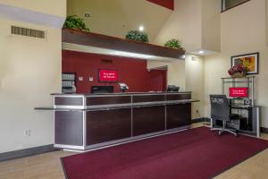 a lobby with a cashier counter and two chairs at Red Roof Inn Pensacola Fairgrounds in Pensacola
