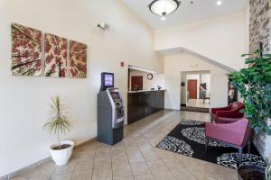 a waiting room with a atm in a building at Red Roof Inn Carrollton in Carrollton