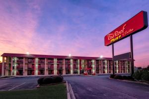 a hotel building with a sign in front of it at Red Roof Inn PLUS+ Huntsville – Madison in Madison