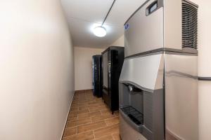 a corridor of a room with a television at Red Roof Inn PLUS+ Huntsville – Madison in Madison