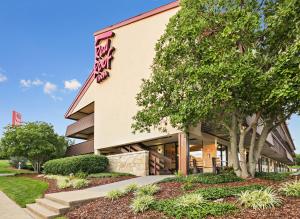 a building with a tree in front of it at Red Roof Inn Johnson City in Johnson City