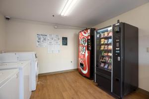 a coca cola refrigerator in a room at HomeTowne Studios by Red Roof Lake Charles - Sulphur in Sulphur