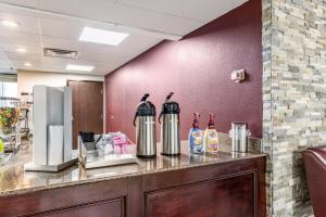 a counter with two kettles on top of it at Red Roof Inn PLUS & Suites Houston - IAH Airport SW in Houston