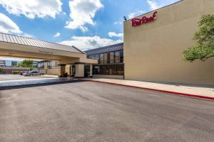 a parking lot in front of a hotel at Red Roof Inn PLUS & Suites Houston - IAH Airport SW in Houston