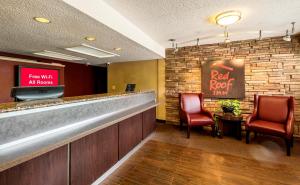 a bar with two chairs and a red roof restaurant at Red Roof Inn Tinton Falls-Jersey Shore in Tinton Falls