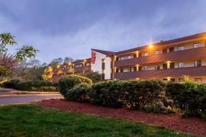 a hotel with bushes in front of a building at Red Roof Inn Tinton Falls-Jersey Shore in Tinton Falls