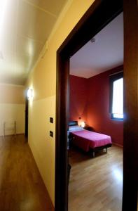 a bedroom with a bed in a red room at Albergo Delle Industrie in Casalmaggiore