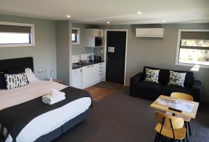 a bedroom with a bed and a couch and a table at High Country Retreat - Lake Tekapo in Lake Tekapo