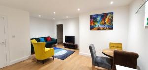 a living room with a couch and a table at Garland Stylish Apartment 2 In Greater London in London