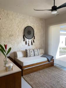 a living room with a couch and a fan at Kaanal Tulum in Tulum +18 photos