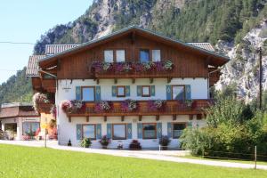 a building with flower boxes on the front of it at Komfort Appartement Royal Windberger in Schladming