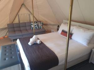 a bedroom with a bed and a couch in a tent at BIG4 Taggerty Holiday Park in Taggerty