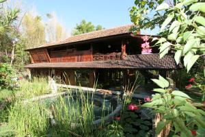 a house with a pond in front of it at Hotel Pondok Sari Beach & SPA Resort in Pemuteran