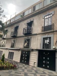 a large building with two garage doors and windows at La Histórica CDMX in Mexico City