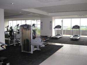 a gym with several tread machines in a room at Dorm Melati Pak Abu in Kuala Lumpur