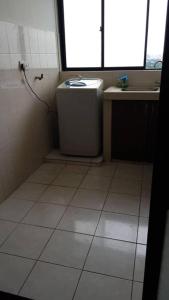 a small bathroom with a toilet and a sink at Dorm Melati Pak Abu in Kuala Lumpur