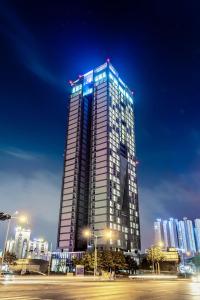 a tall building with lights on it at night at J One Hotel Cheongju in Cheongju