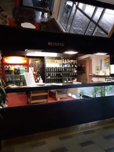 a counter in a store with a bar with alcohol at Hotel Apollo in Valašské Meziříčí