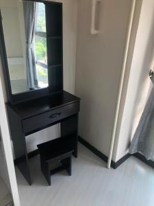 a black dresser with a mirror in a room at The Ceo Suites in Bayan Lepas