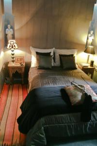 a bedroom with a large bed in a room at Riad Golfame in Marrakesh