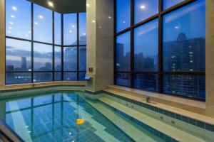 a swimming pool in a building with windows at Hotel Pharos in Seoul