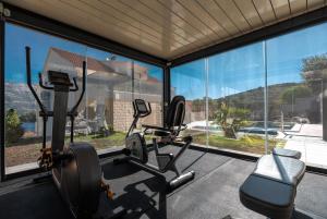 a gym with a large window and two treadmills at WISH Apartments in Korčula