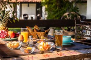 a table topped with bowls of food and drinks at Hotel Mas Des Barres in Saintes-Maries-de-la-Mer