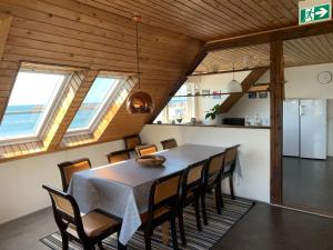 a dining room with a table and chairs at Pakhuset Anholt in Anholt