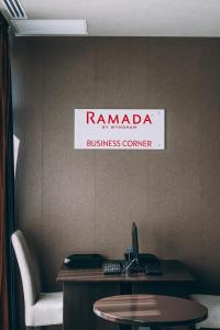 a sign that says ramada business center on a wall at Ramada by Wyndham Constanta in Constanţa